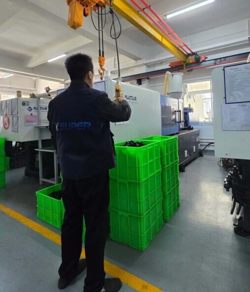 Engineers working on tooling design and debugging on the factory floor