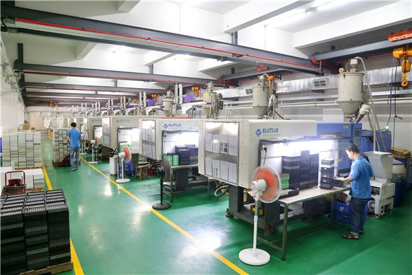 Injection molding factory floor with rows of modern molding machines in a clean production environment